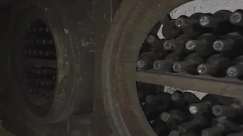 Rows of exclusive wine bottles stacked in a dark wine cellar. Winemaking concept Stock-Footage 303359497