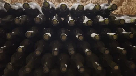 Rows of exclusive wine bottles stacked in a dark wine cellar. Winemaking concept Stock-Footage 306017782