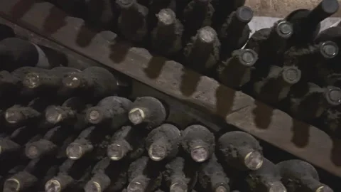 Rows of exclusive wine bottles stacked in a dark wine cellar. Winemaking concept Stock-Footage 306017796