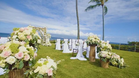 Rows of festive chairs and beautiful flowers in baskets at a wedding ceremony on Stock Footage 101114907