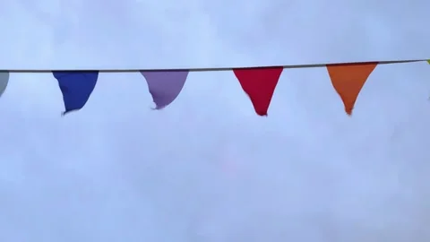 Rows of fluttering triangular flags in a stormy weather. Stock Footage 278022043