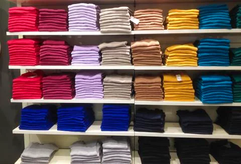 Rows of folded clothes. Fotos Stock