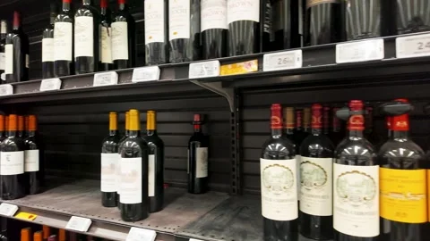 Rows of French Red Wine Bottles on Supermarket Shelves in Paris Stock Footage 335359369