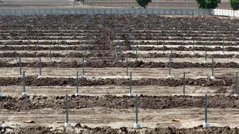 Rows of galvanized steel ground mounting posts installed into neatly prepared Stock Footage 337115722