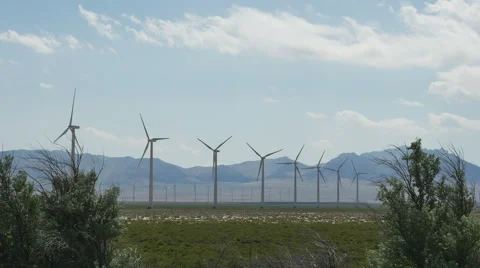 Rows of giant wind turbines turn in desert Stock Footage 64680050