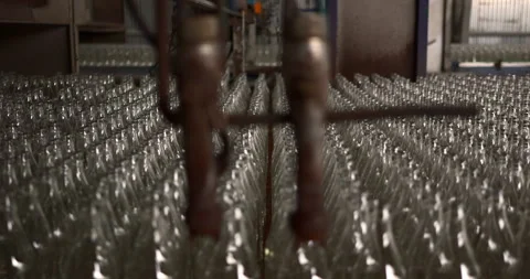 Rows of glass bottles lined up for efficient packaging on global supply lines Stock Footage 303107601