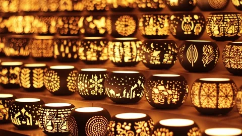 Rows of glowing ceramic tealight holders at a Christmas market stall Stock Footage 322793151