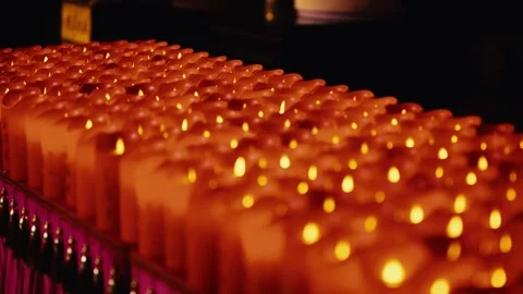 Rows of glowing prayer candles illuminate a Buddhist temple in China. Stock Footage 346642280