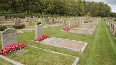 Rows of Graves with red flowers at Cemetery, Pan Shot 動画素材 222946672
