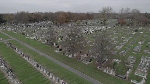 Rows of graves with tombstones, graveyard on cloudy autumn day Stock Footage 167873176