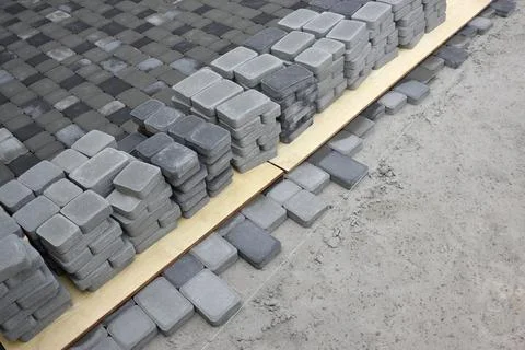 Rows of gray and dark grey walkway slab lying outdoors. Material for Paving.. Stock Photos