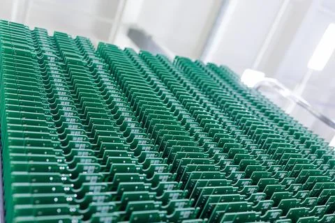 Rows of green printed circuit boards in electronics manufacturing plant 스톡 사진