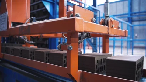 Rows of grey cement bricks are moving on a plant line, close up view Stock Footage 128160341