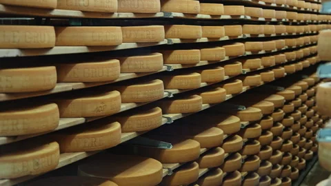 Rows of Gruyère Cheese Aging on Wooden Shelves, Switzerland Stock Footage 320263152