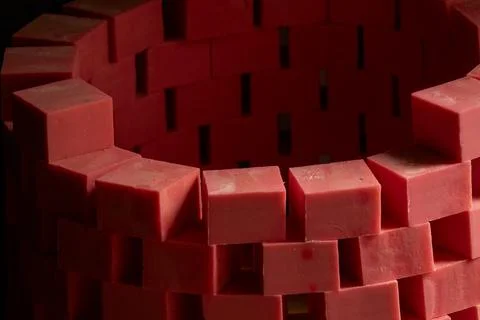 Rows of handmade red soap bars dry in wooden molds at a traditional worksho.. Stock Photos