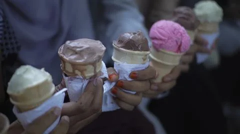 Rows of hands are bringing Ice Cream Cones. Foto stock