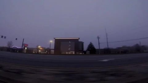 Rows of hotels illuminated lighting early morning fog and traffic on Belair r Stock Footage 171390282