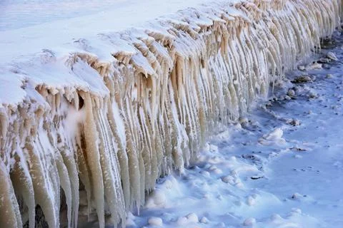 Rows of icicles on the embankment Stock Photos