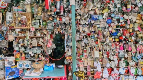 Rows of kitchen utensils crockery hang outside a shop Video stock 298956357