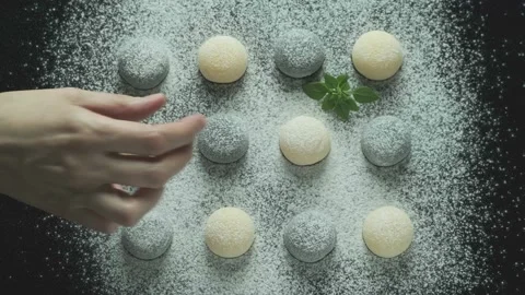 Rows of light and dark buns sprinkled with powdered sugar or sweet soy flour on Stock Footage 178490187