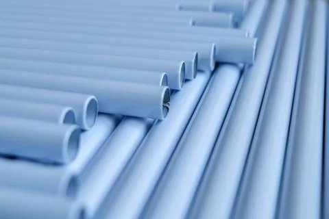 Rows of light gray PVC pipes arranged in a wave pattern 写真素材