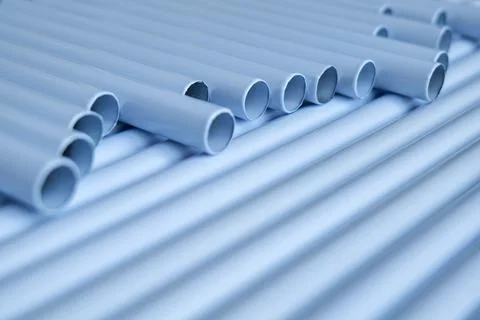 Rows of light gray PVC pipes arranged in a wave pattern 写真素材