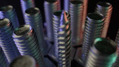 Rows of long bolts and nails on a table with a dark surface. Shiny metal, steel Stock Footage 160111759