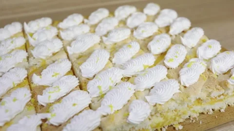 Rows of lot small cakes with whipped cream - sweet food Stock Footage 276364133