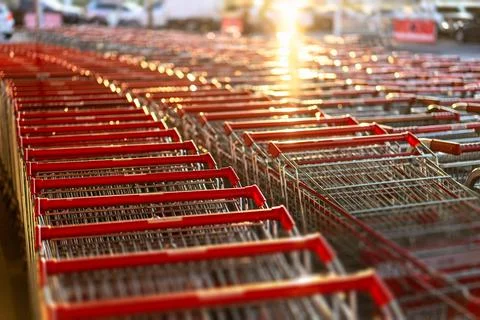 Rows with lots of shopping carts in a large supermarket Stock Photos