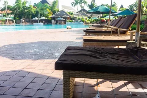 Rows of lounge chairs by the pool Stock Photos