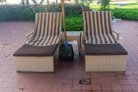 Rows of lounge chairs by the pool Stock Photos