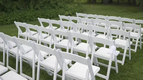 Rows of many empty chairs standing on green grassy lawn Stock Footage 304985196