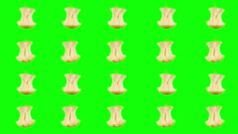 Rows, many stubs of a ripe yellow apple that have been bitten off rotate on a Stock Footage 162404898