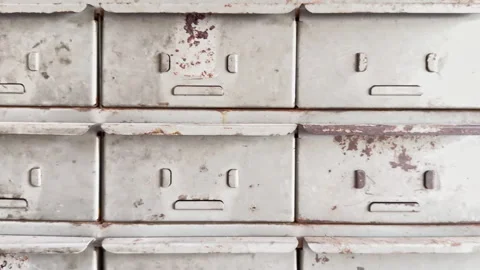 Rows of metal drawers show weathered, rusty faces Video stock 344906059