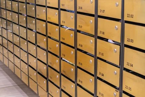 Rows of metallic mailboxes in postal room of condominium building Foto stock