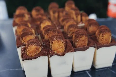 Rows of mini desserts with chocolate and pastry topping Stock Photos