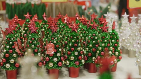 Rows of miniature Christmas trees in festive store. Christmas decorations shop. Stock Footage 294672637