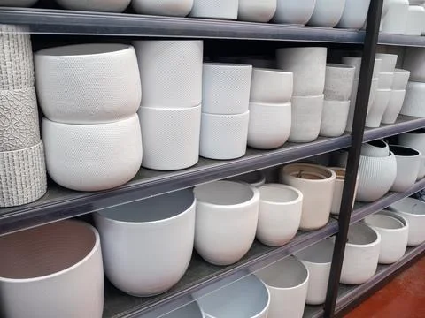 Rows of modern ceramic flower pots on shop shelves Stock Photos