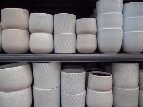 Rows of modern ceramic flower pots on shop shelves Stock Photos