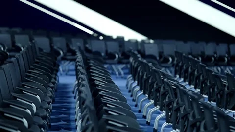 Rows of modern ergonomic chairs in a large auditorium under dramatic blue Video stock 325669222