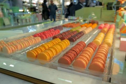 Rows of multicolored macaroons in a bakery window Stock Photos