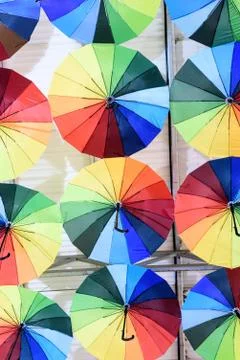 Rows of multicolored umbrellas creates a surreal abstract background Stock Photos