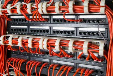 Rows of network cables connected to router and switch hub Stock Photos