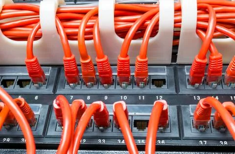 Rows of network cables connected to router and switch hub Stock Photos