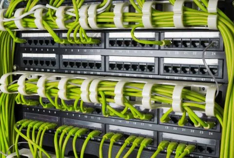 Rows of network cables connected to router and switch hub Stock Photos