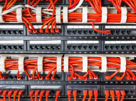Rows of network cables connected to router and switch hub Stock Photos