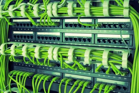 Rows of network cables connected to router and switch hub Stock Photos