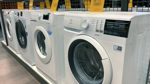 Rows of new washing machines stand in an appliance store Stock Footage 236071837