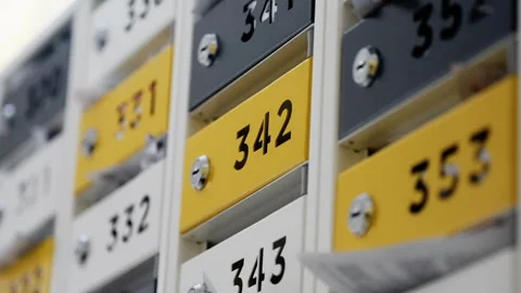 Rows of numbered mailboxes and parcel lockers with yellow and gray panels in a Stock Footage 317570022