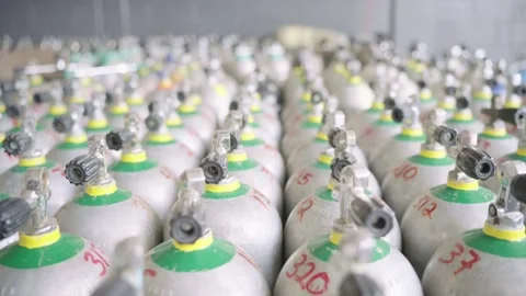 Rows of numbered scuba diving aluminum air tanks stored in a large warehouse 스톡 동영상 340152362